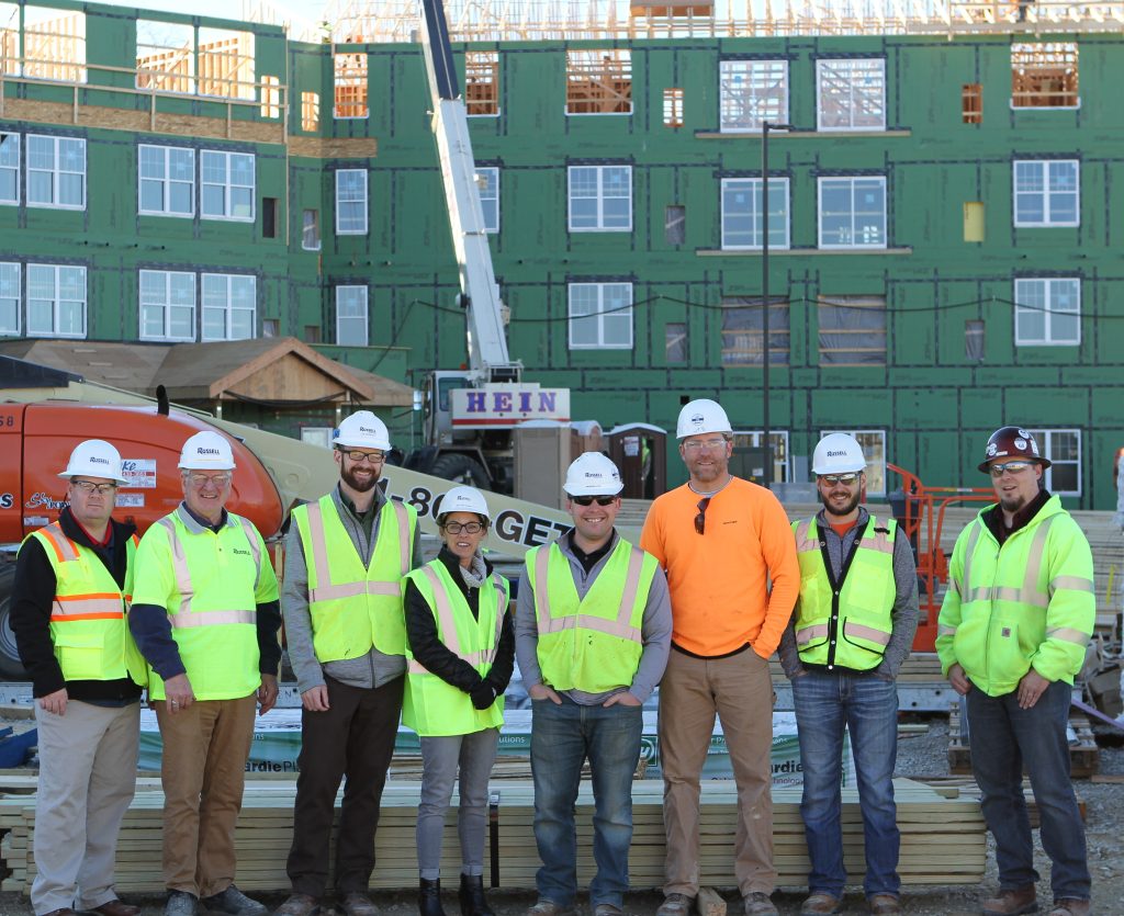 Project team in front of Overlook Village under construction