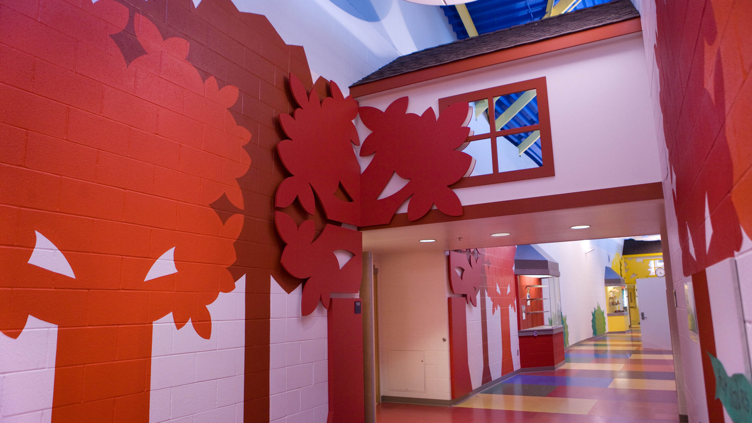 elementary school hallway with tree artwork