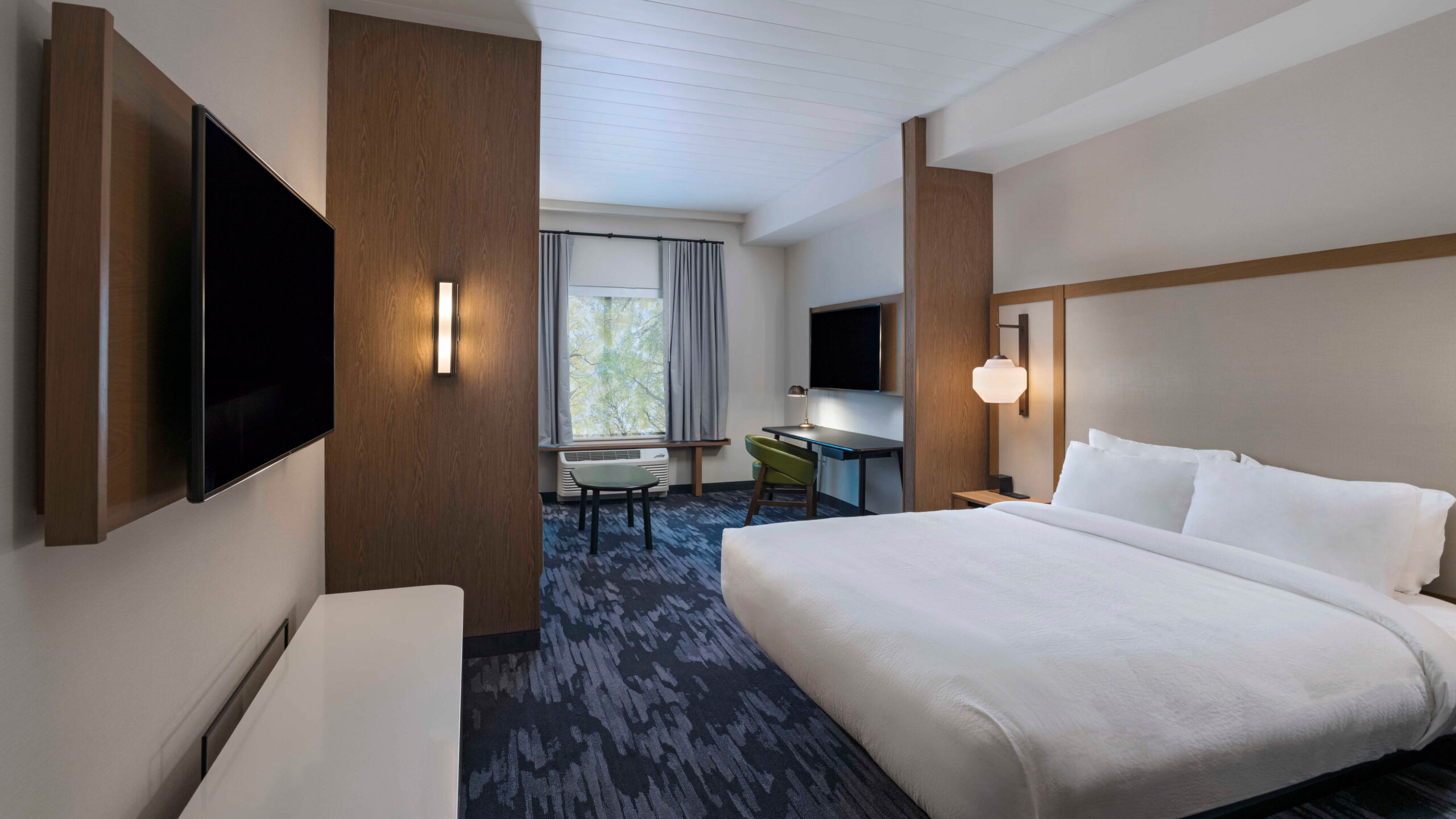 Hotel room with king-size bed and tv