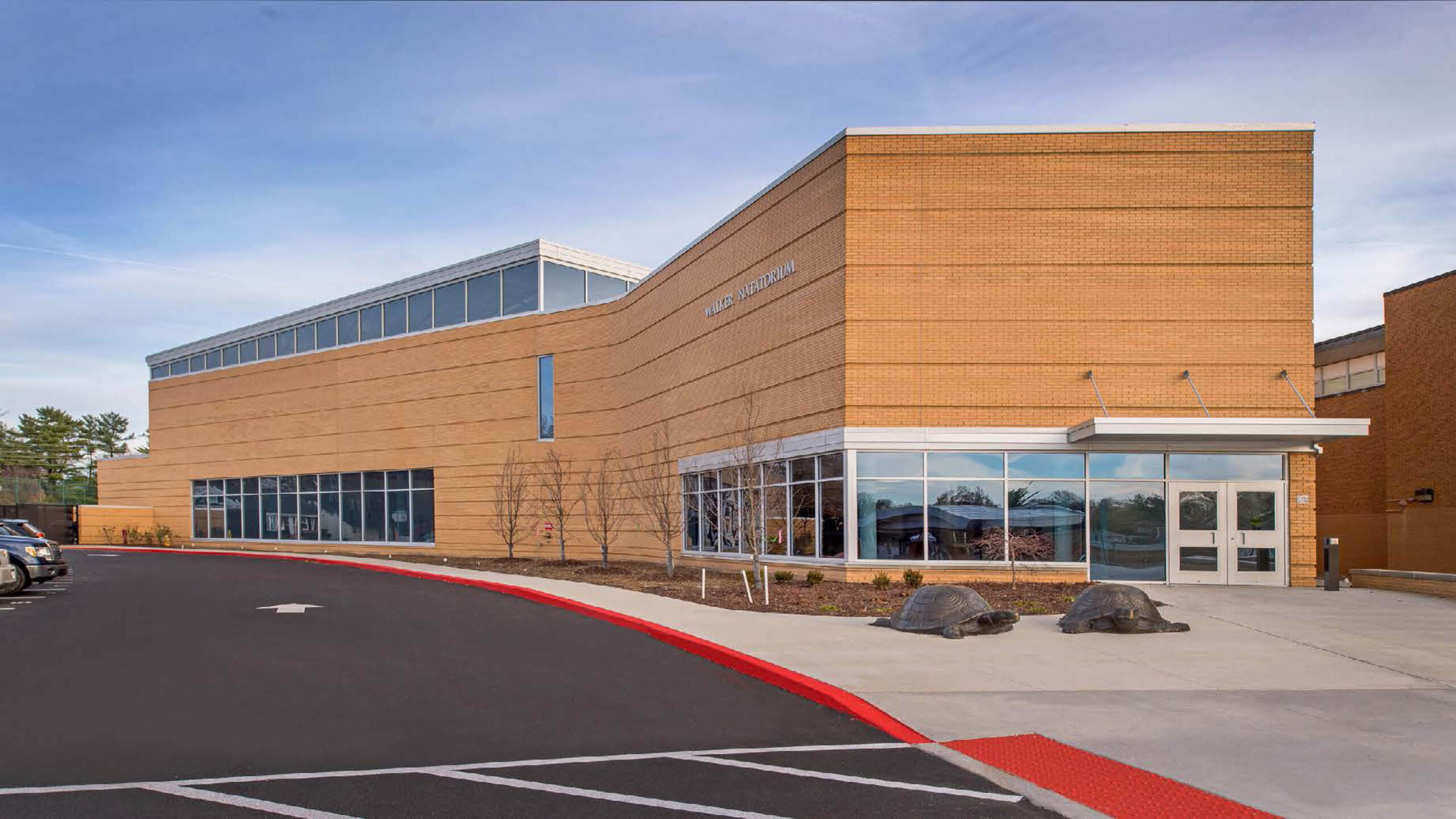 Exterior shot of an athletic center and parking lot