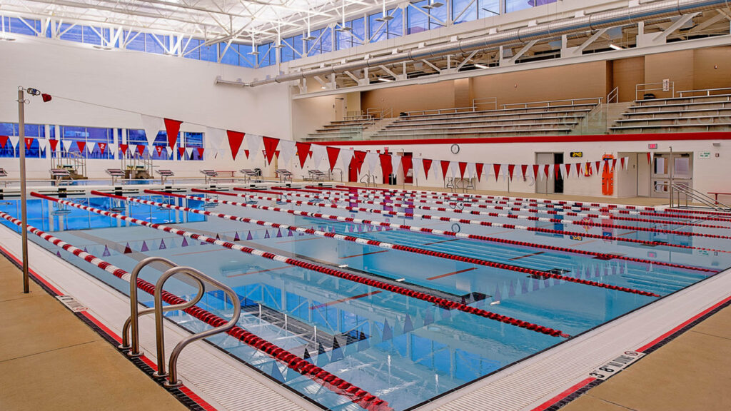 Indoor swimming pool with bleachers behind