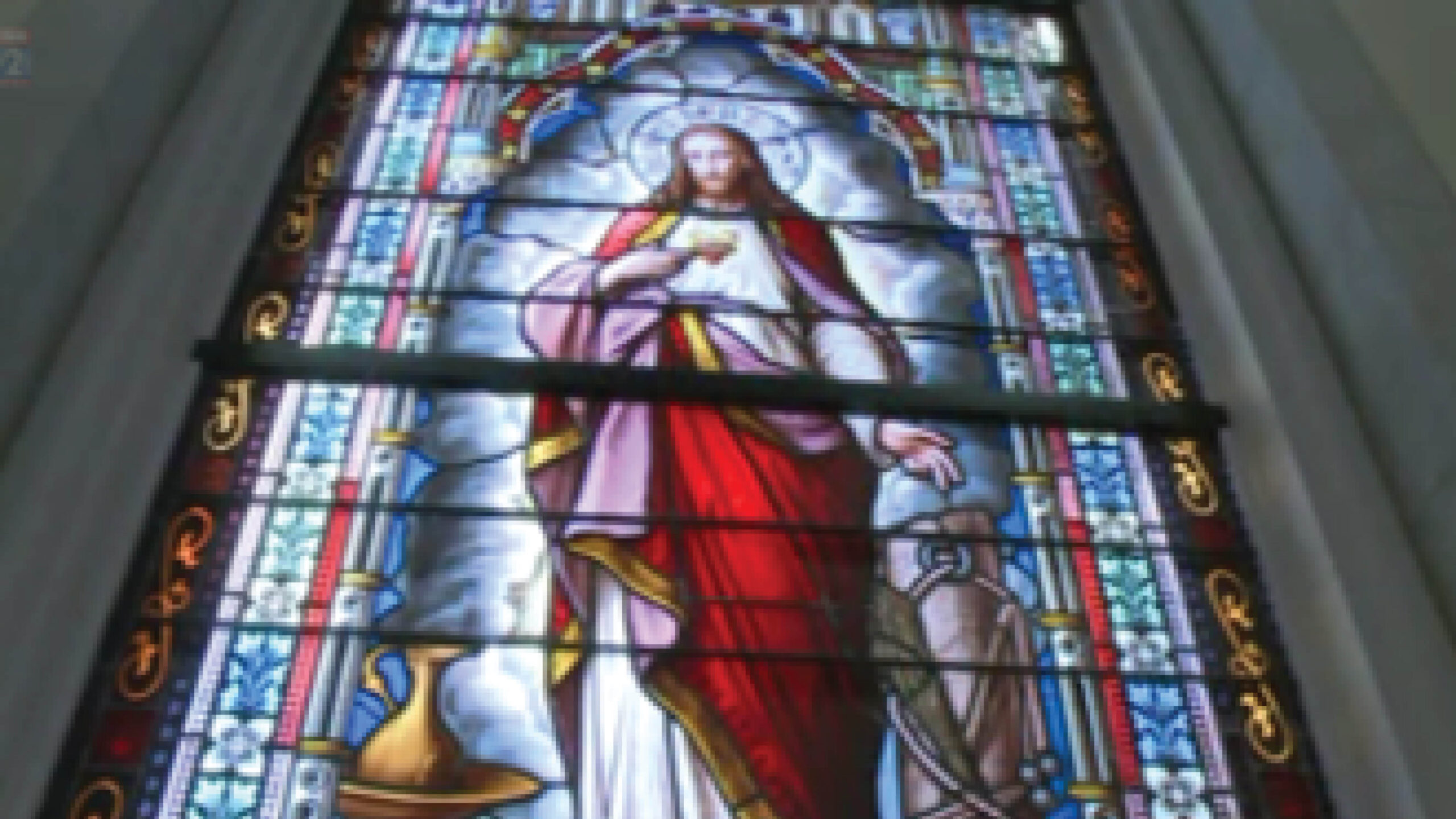 stained glass window with an image of Jesus