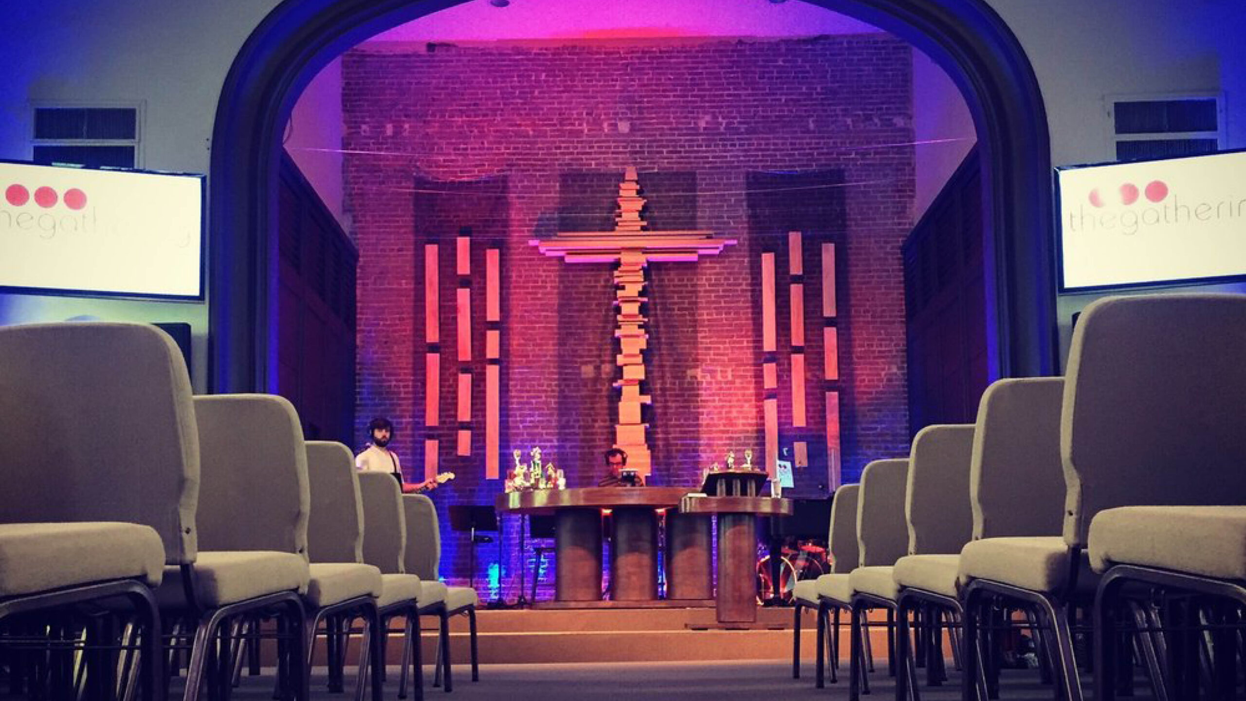 Church sanctuary seating with screens on either side of the stage