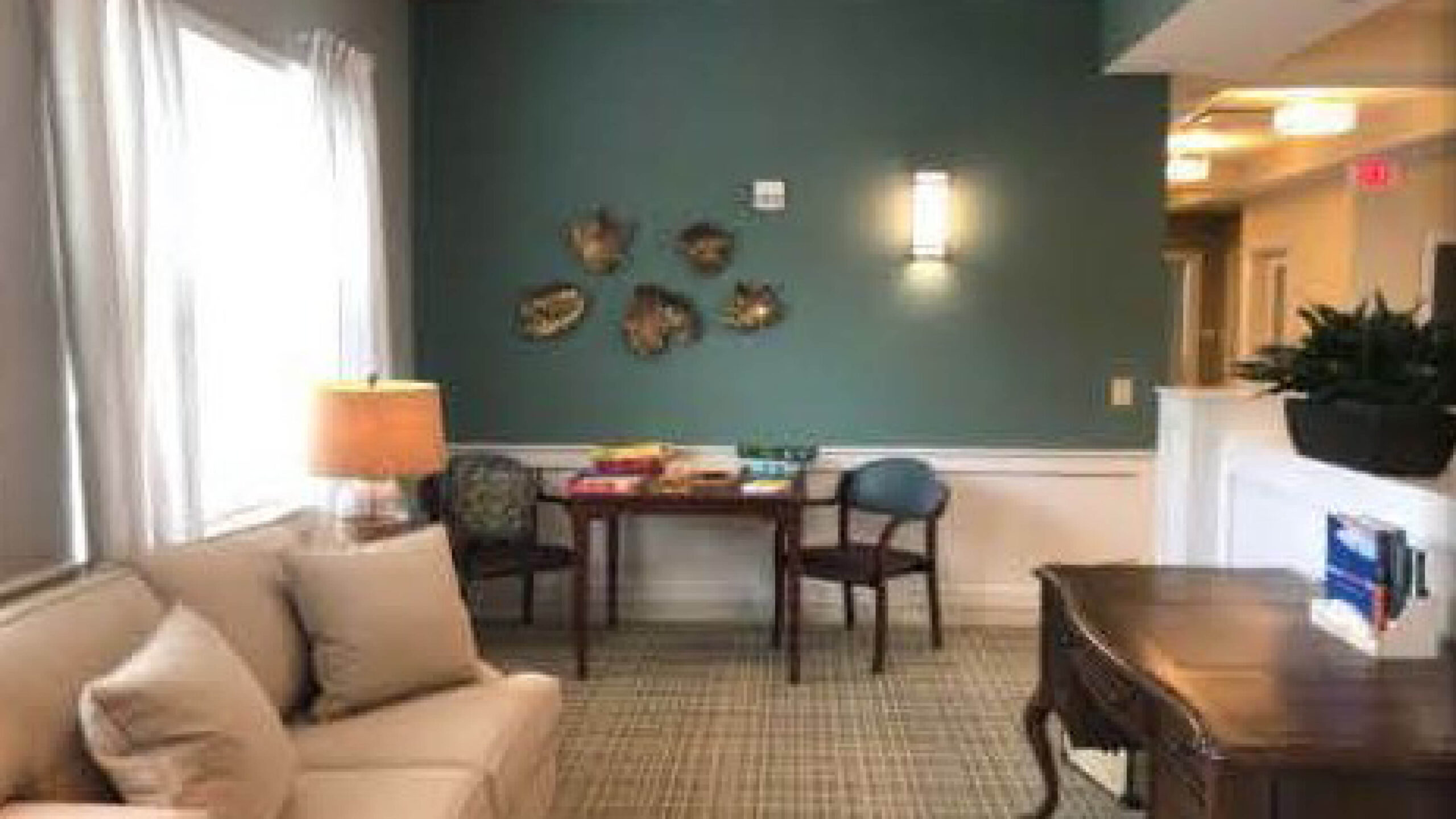 living room with a couch, tables, and chairs