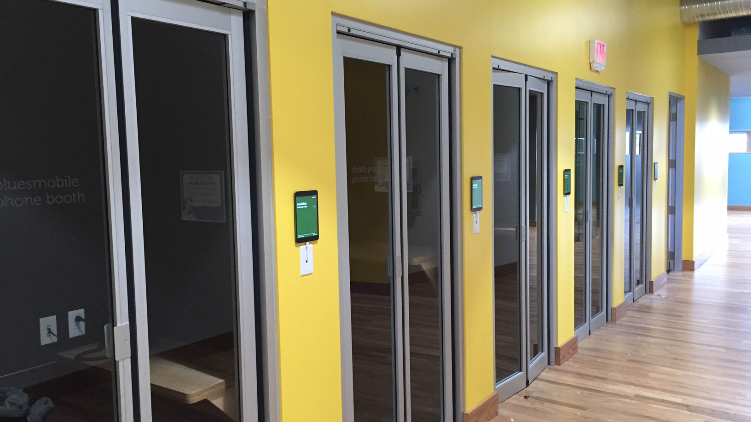 hallway lined with doors to office spaces