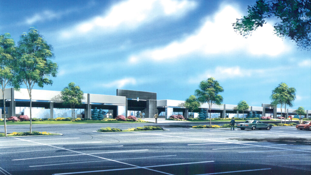 exterior view of an office building and parking lot with trees and landscaping