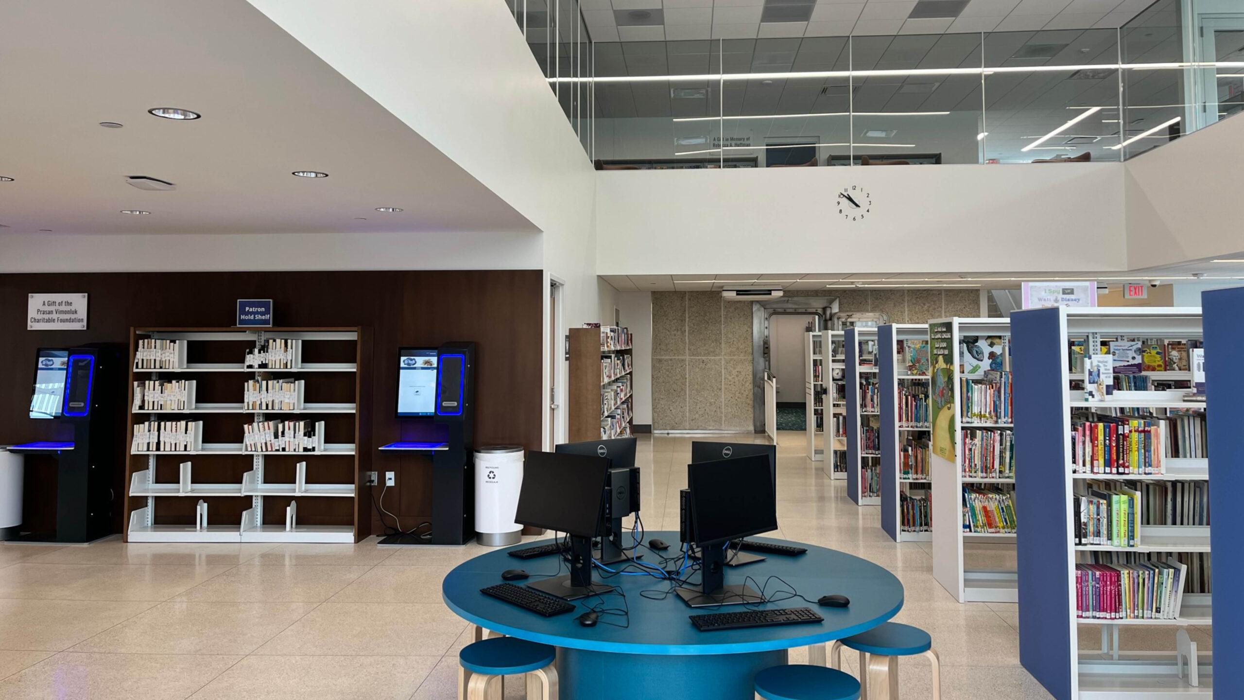 library space with a table of computers and bookshelves