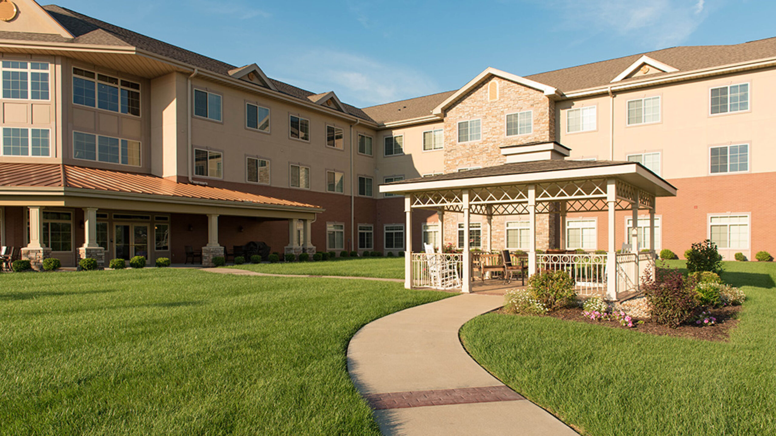 senior living facility exterior with gazebo and sidewalk