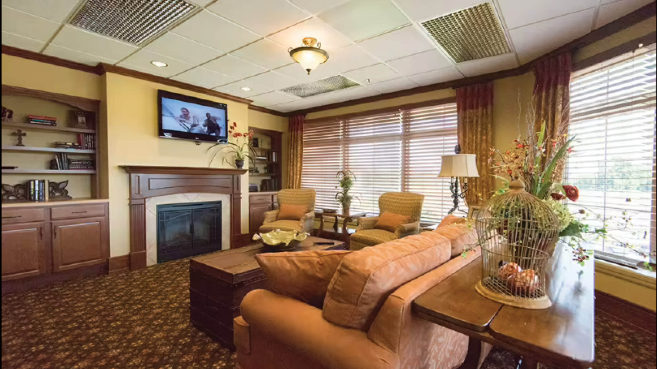 living room space with couch, tables, and a fireplace