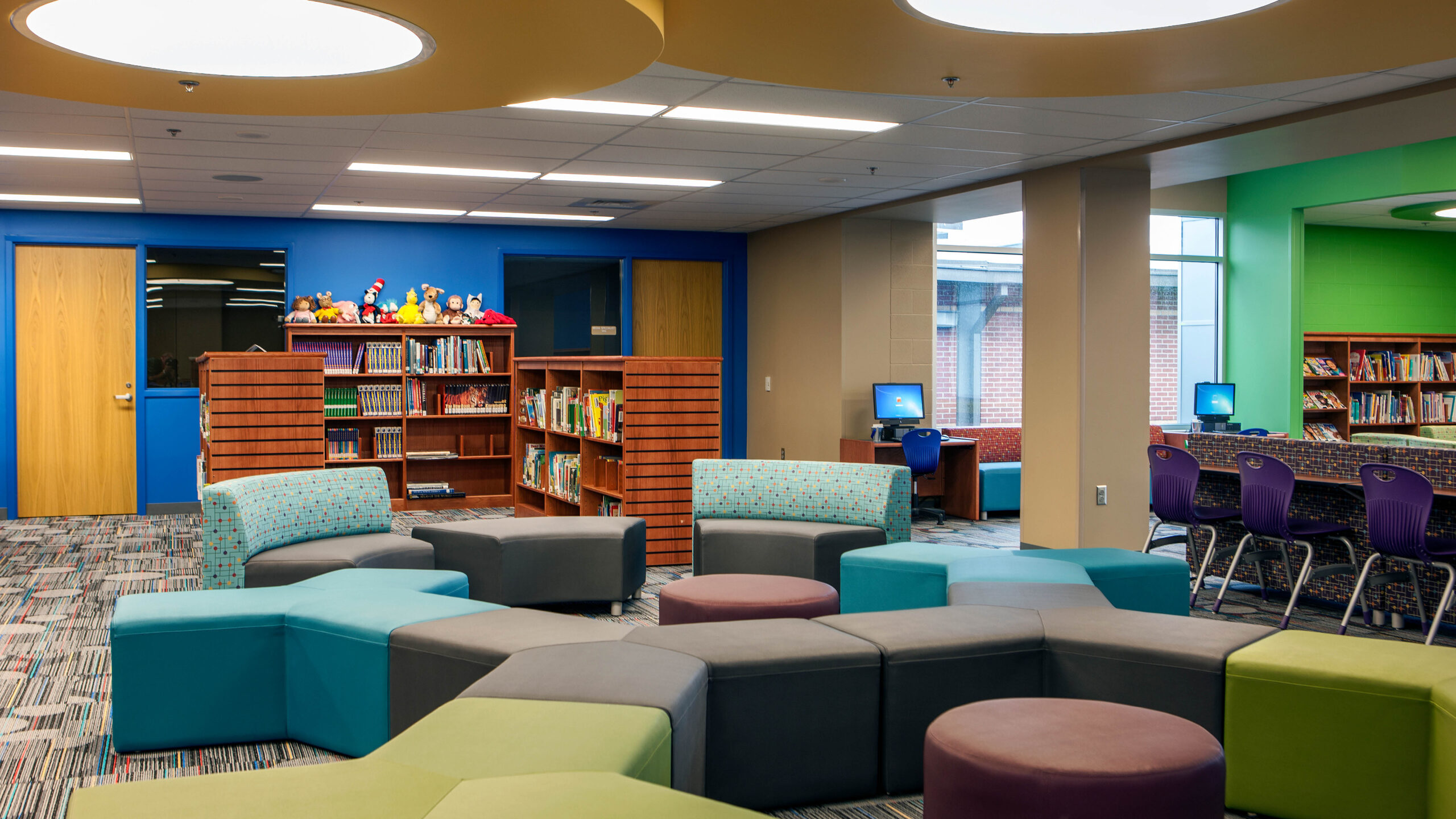 library with filled bookshelves and a variety of couches