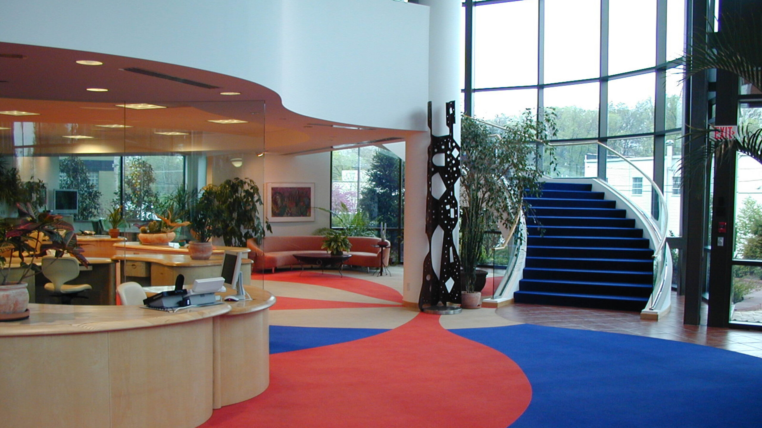 waiting area with reception desk and stairs