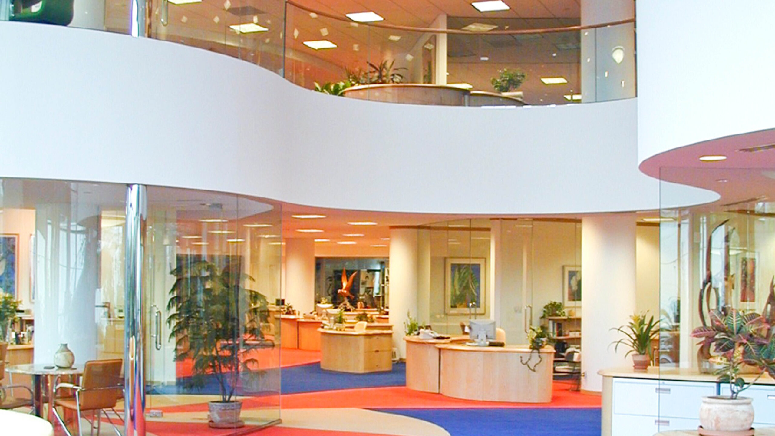 open office space with meeting rooms enclosed in glass