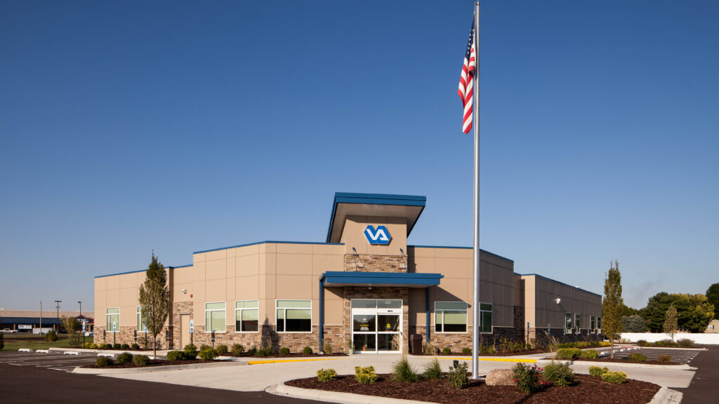 exterior view of a VA clinic and an American flag