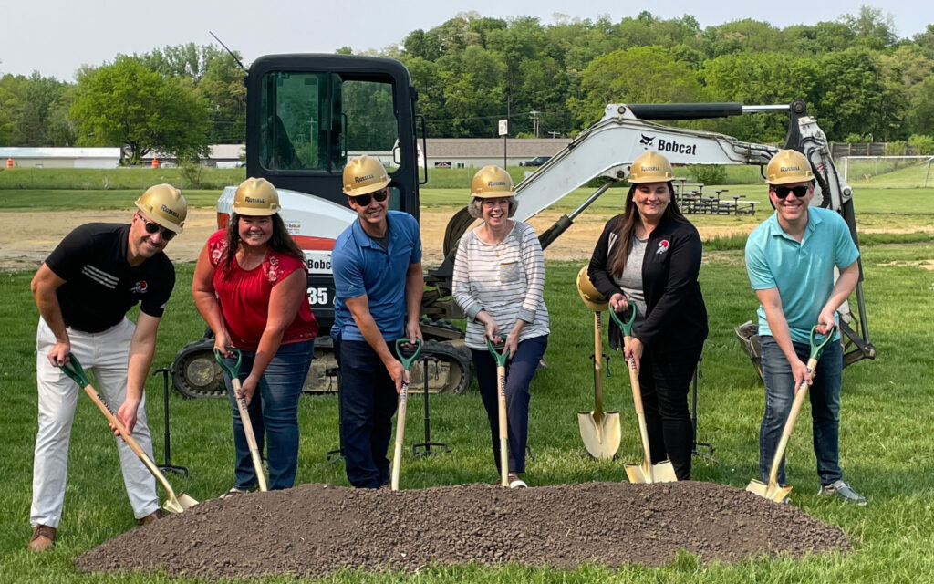 Members of the Quad Cities Christian School board shoveling dirt during a groundbreaking ceremony