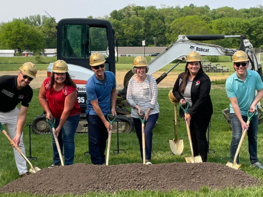 Members of the Quad Cities Christian School board shoveling dirt during a groundbreaking ceremony