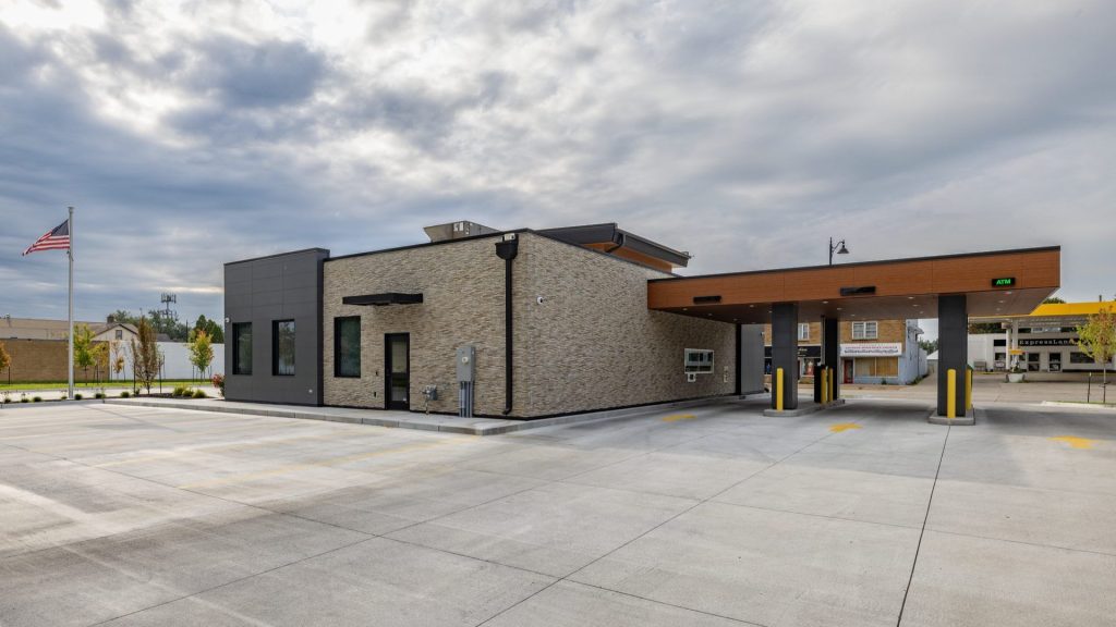 Exterior of the DuTrac Community Credit Union branch in Moline, with a stone-faced building and drive-up ATM canopy.