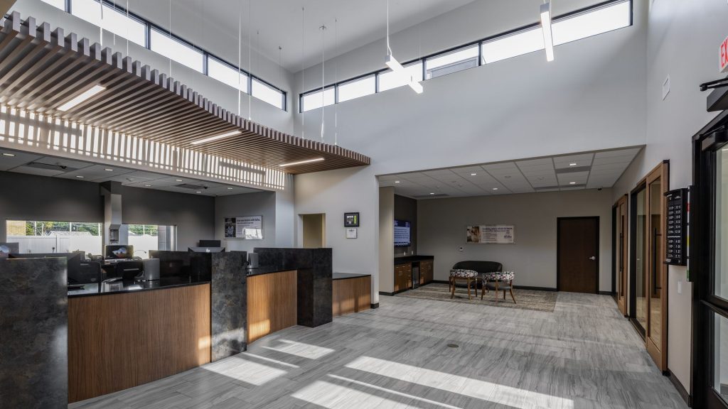 DuTrac Community Credit Union branch lobby in Moline, with a teller counter, wood slat ceiling, and tall windows.
