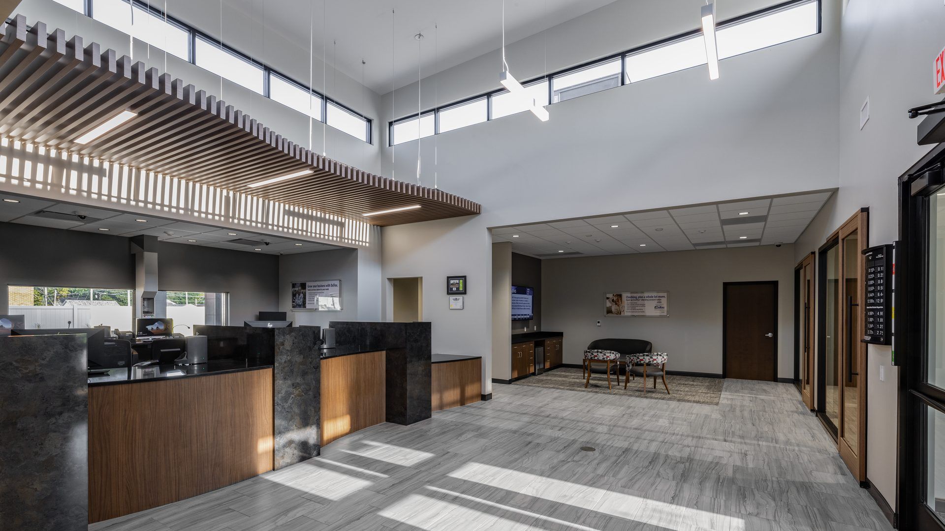 DuTrac Community Credit Union branch lobby in Moline, with a teller counter, wood slat ceiling, and tall windows.
