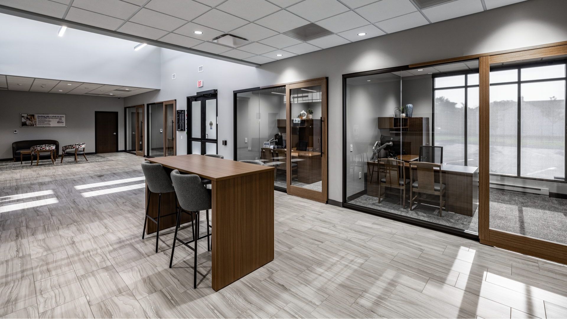 Interior of the DuTrac Community Credit Union branch in Moline, with a high-top table and glass-walled private offices.