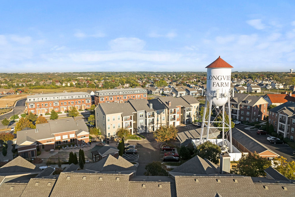 Aerial view of Village at New Longview apartments and townhomes beside the Longview Farm water tower in Lee's Summit, Missouri