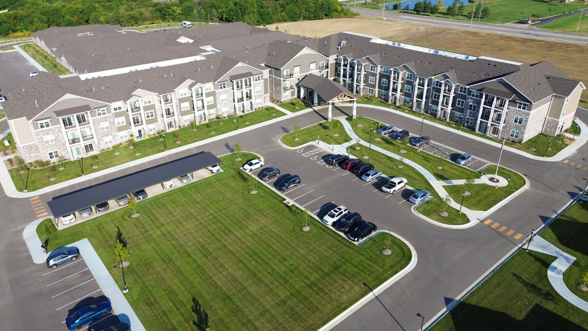 Aerial view of The Rushwood Senior Living in Wichita, Kansas, showing the main entrance canopy, carport, and landscaped grounds