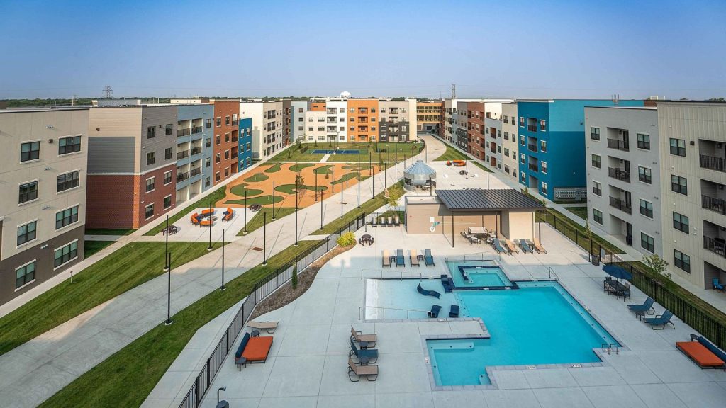 Aerial view of the Union Mill courtyard in Wichita, Kansas, with a pool, putting green, pickleball court, and surrounding apartment buildings