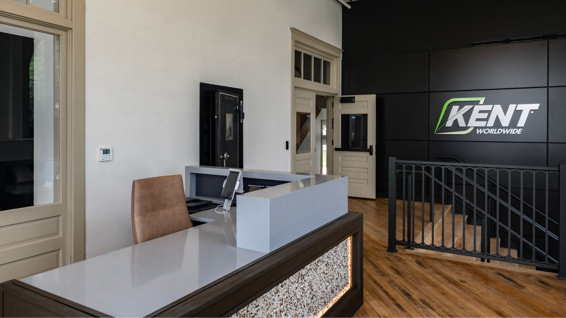 McKee Building lobby with preserved historic vault, wood trim, and Kent Worldwide branded wall