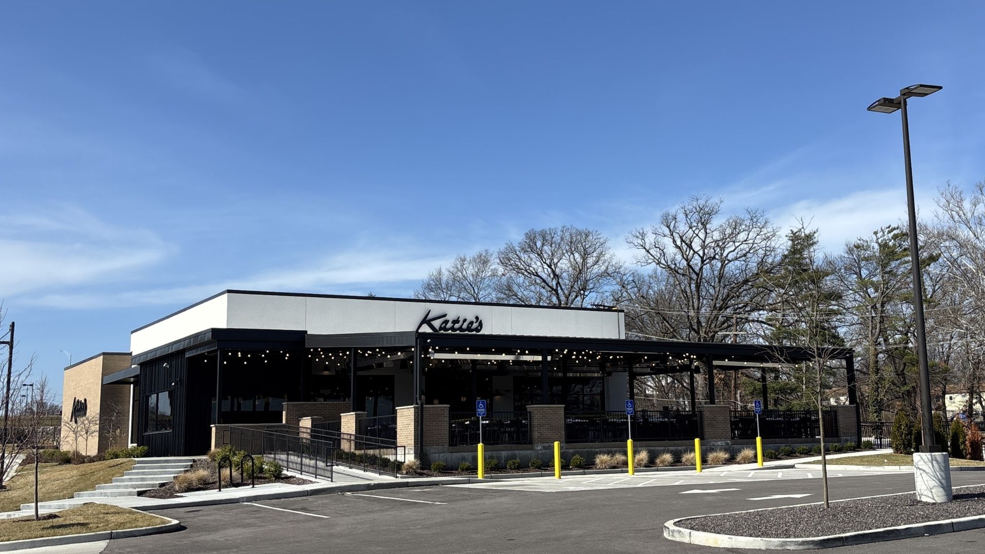 Katie's Pizza restaurant exterior in Crestwood, MO with covered outdoor patio and string lighting