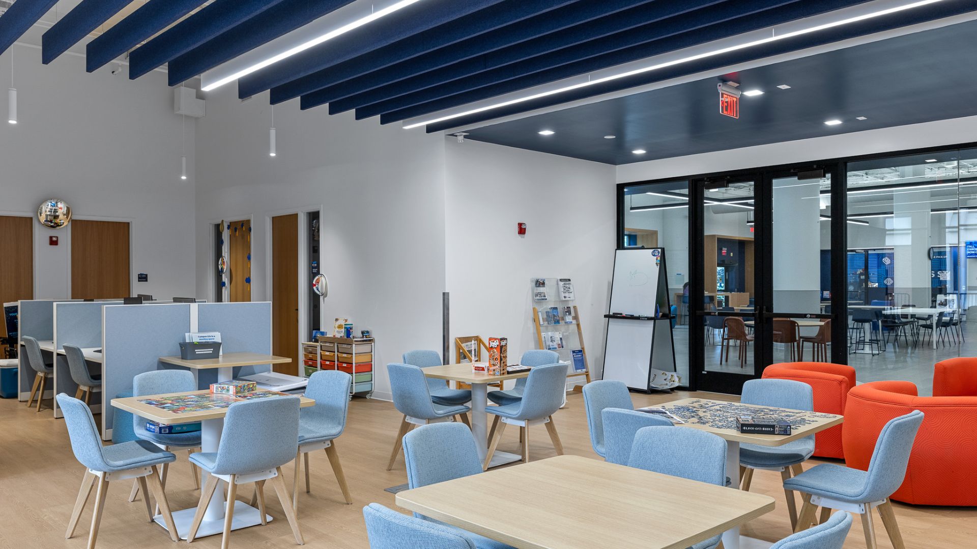 STLCC Meramec Student Center game and study lounge with blue seating and acoustic ceiling baffles