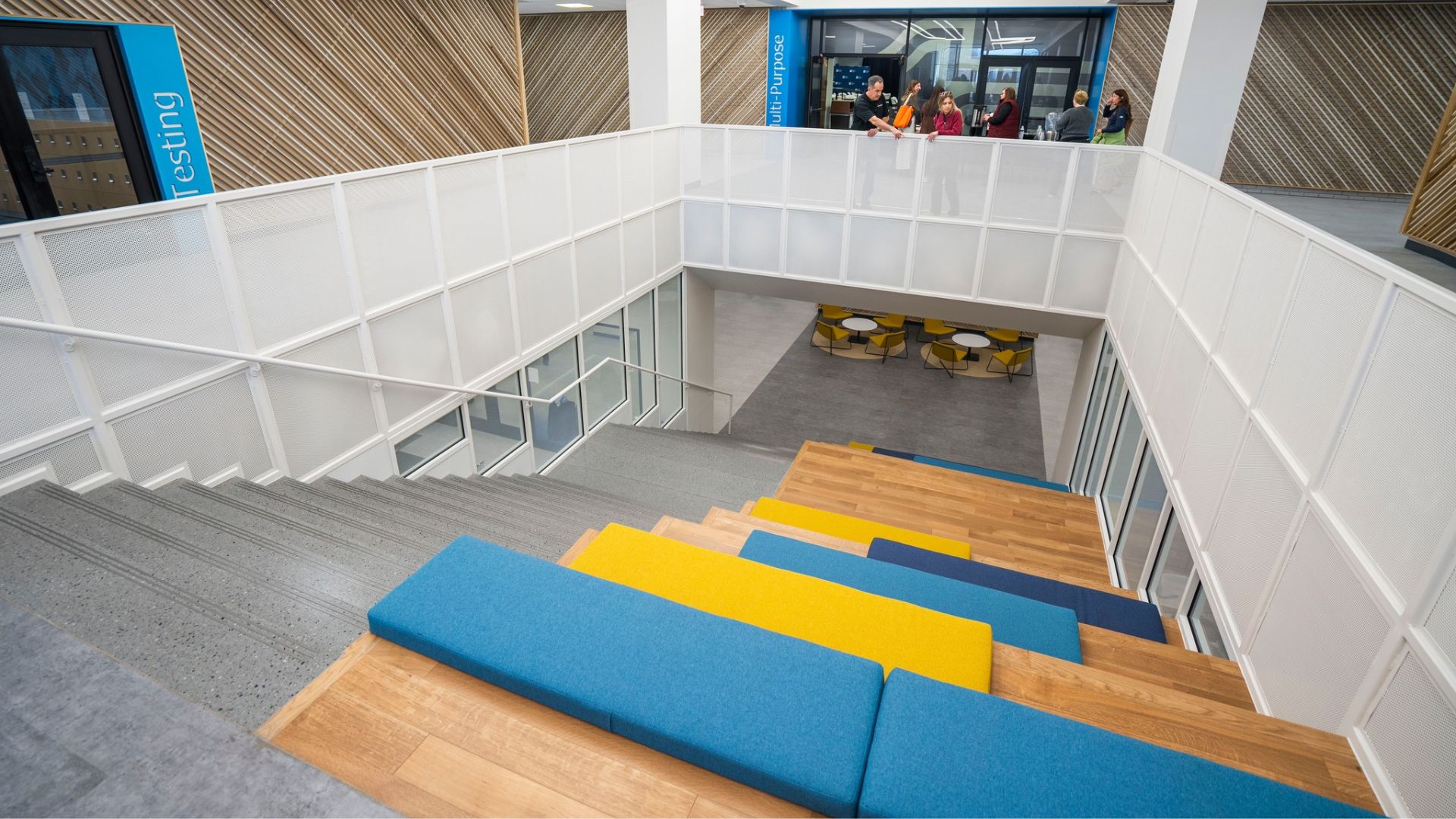 STLCC Florissant Valley new grand stair with wood-topped seating and views into multi-purpose space