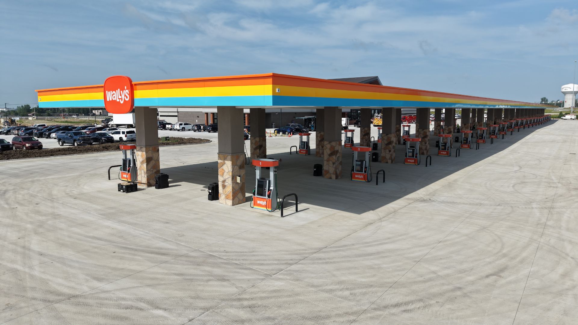 Wally's fuel station with colorful striped canopy over multiple pump islands
