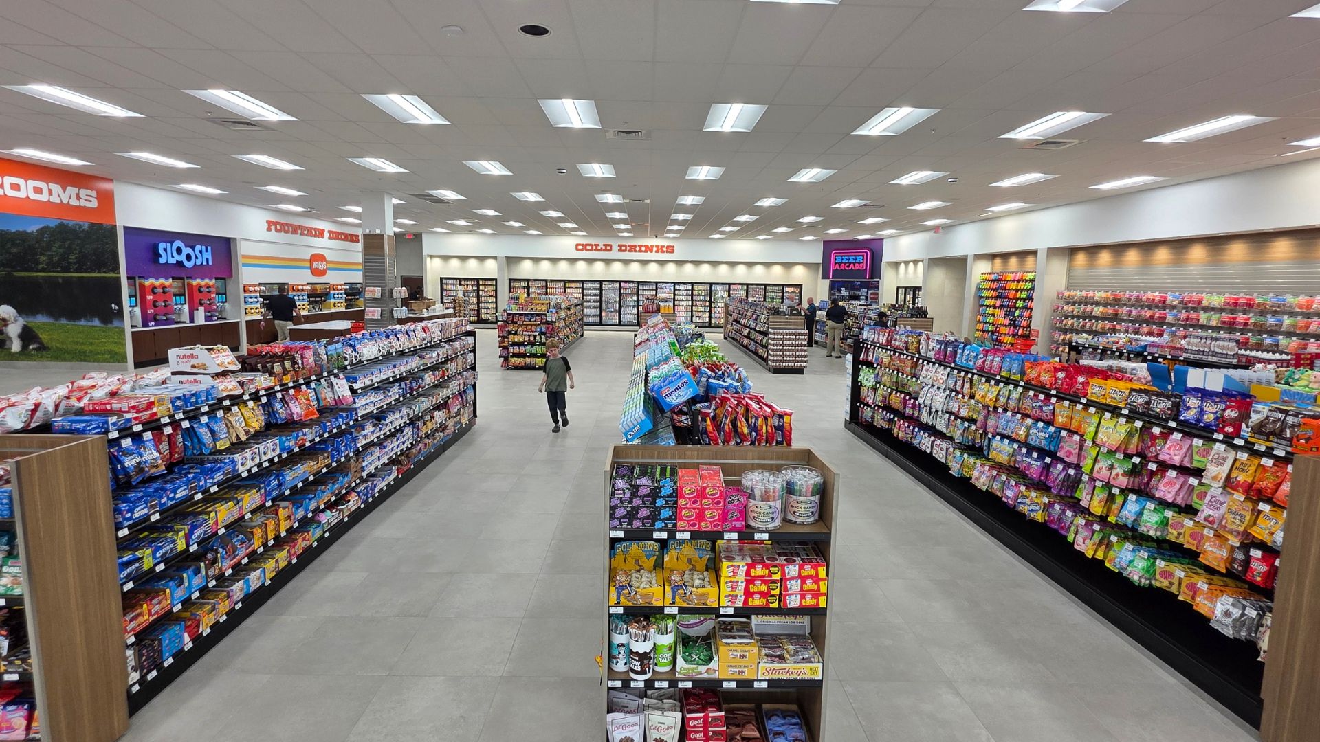 Interior of Wally's convenience store with snack aisles and cold drink coolers