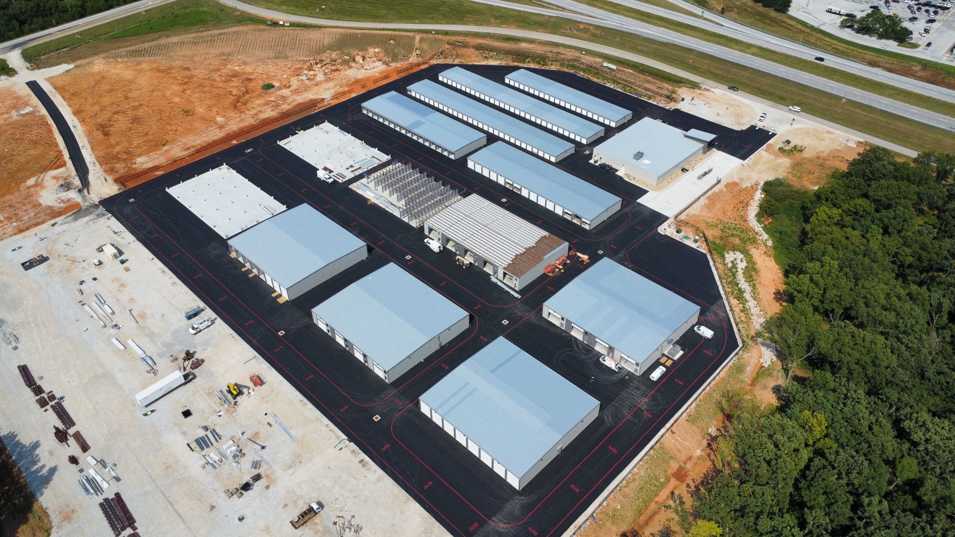 Aerial view of the Southway Storage site under construction, with multiple rows of drive-up storage buildings and paved drives.