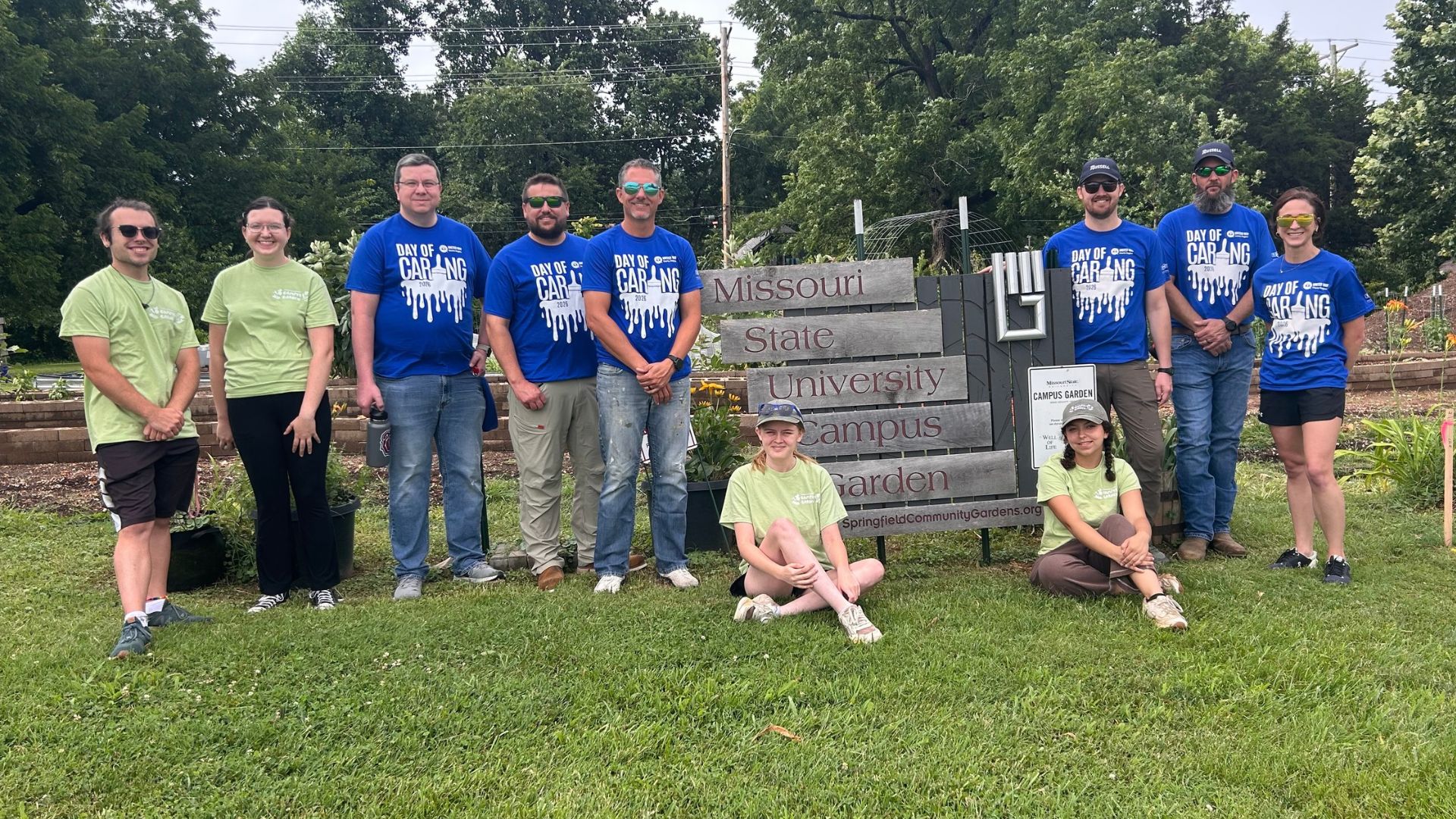 Russell volunteers in blue Day of Caring shirts at the Missouri State University Campus Garden in Springfield, Missouri