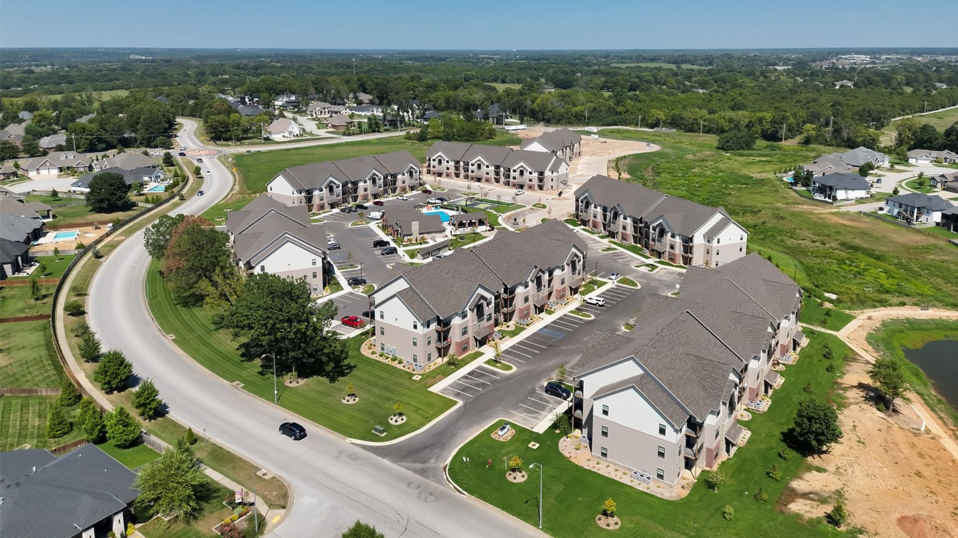 Aerial view of The Meadows at Wicklow apartment buildings, clubhouse, and pool in Nixa, MO, built by Russell Construction