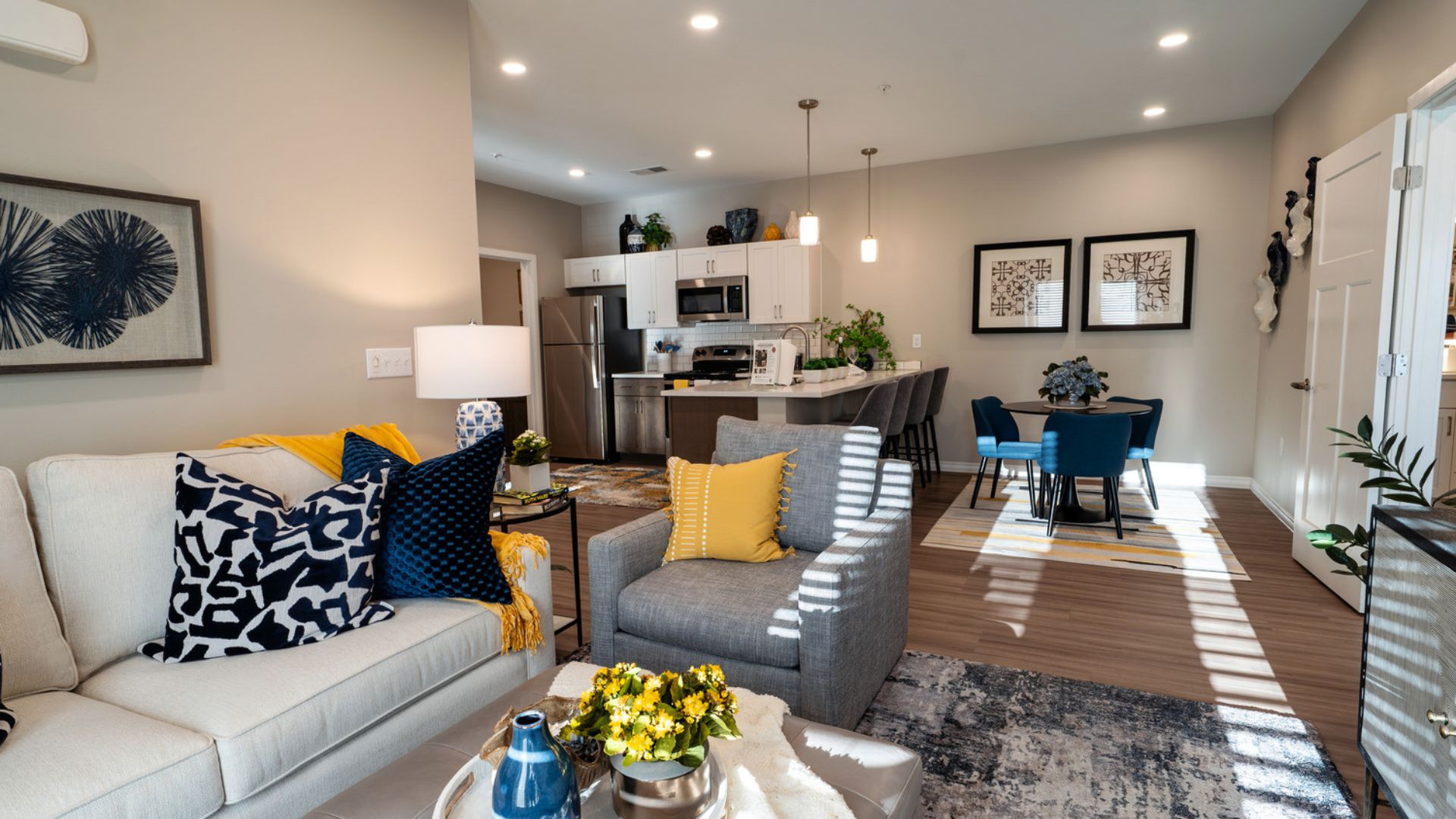 Open concept living room and kitchen in a model apartment at The Meadows at Wicklow in Nixa, MO
